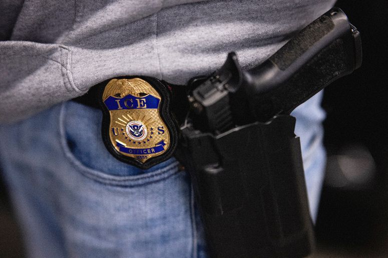 Image may contain: Firearm, Gun, Handgun, Weapon, Badge, Logo, Symbol, Adult, and Person