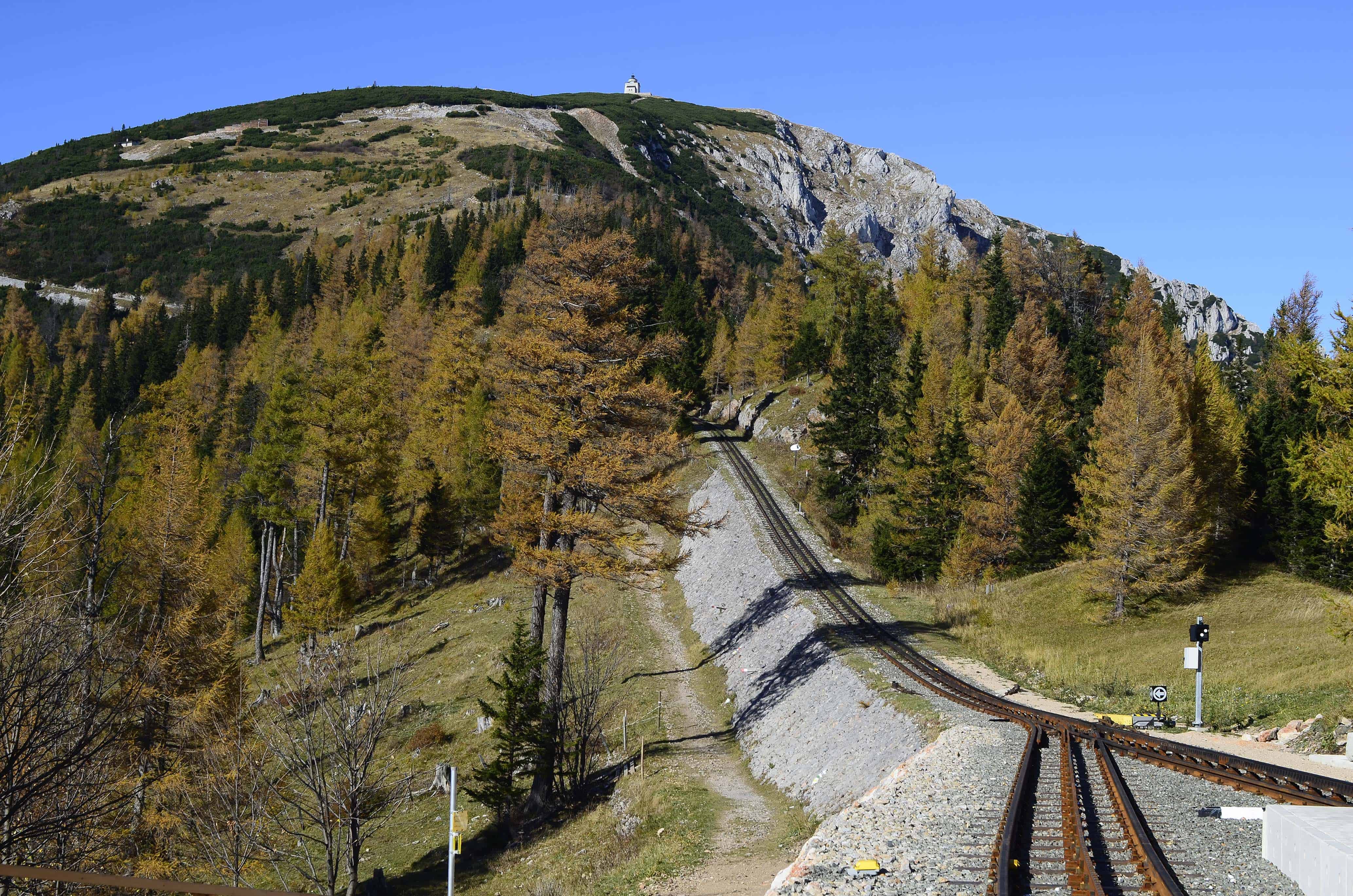 Algunos trenes de cremallera austríacos, como el que va a la montaña Schneeberg, con una capilla conmemorativa en su cumbre, ofrecen bellos paisajes en otoño.